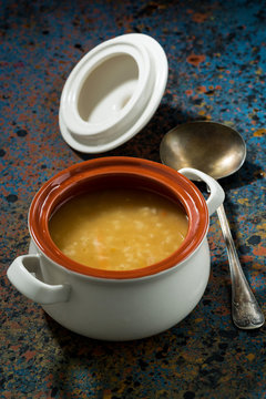 pot of lentil soup on a dark background, vertical