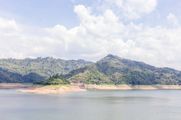 Natural mountain and water reservoir dam under cloudy sky, natural irrigation system.