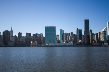 Fototapeta na wymiar Buildings over river with blue sky, New York