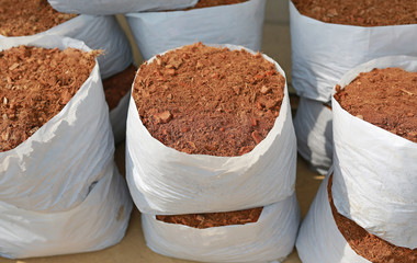 coconut spathe fiber in sack, the pile of coconut husk, Natural substance added to soil or land to...