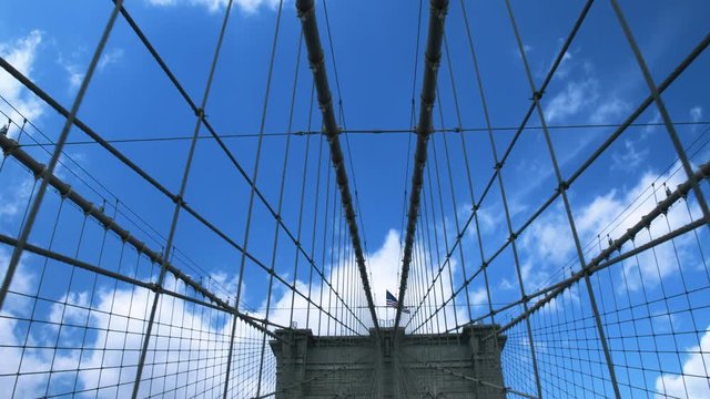 The Supports Of The Brooklyn Bridge .Steadycam shot . The American Flag above