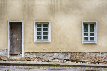 Old two windows and door with grunge cracked wall