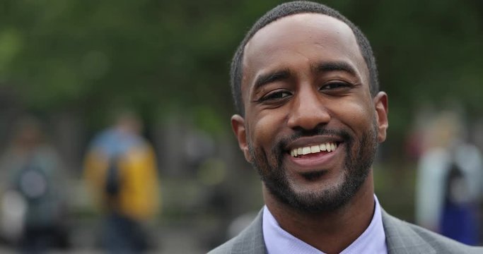 Black business man in city park face portrait smile