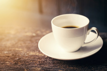 Espresso Coffee or Americano black Coffee in White cup on wood table with copy space.