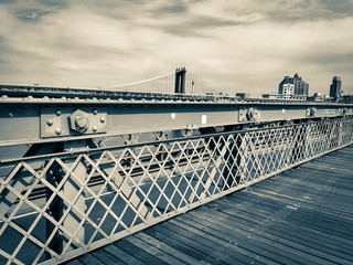 Fototapeta premium Fence and walkway at Brooklyn bridge and Manhattan bridge in vintage style