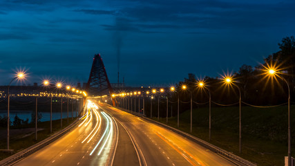Fototapeta na wymiar Night road in the city with car lights in Novosibirsk, Russia