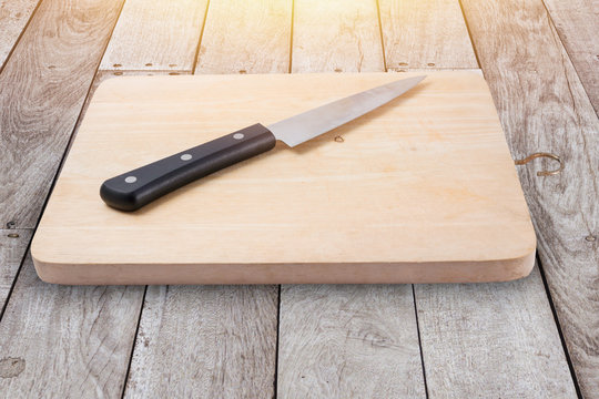 wood chop board or cutting board with kitchen knife on wood floor.