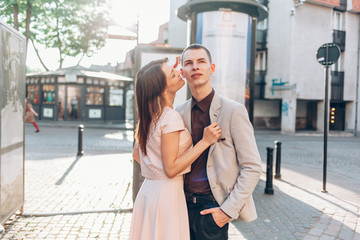 beautiful couple kissing on the street in summer