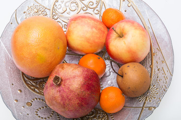 mix fresh fruits on plate isolated on white