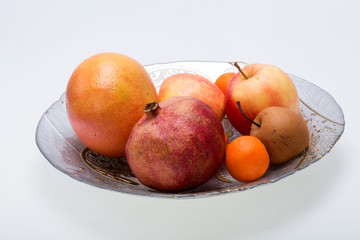 Fototapeta na wymiar mix fresh fruits on plate isolated on white