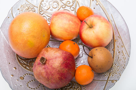 mix fresh fruits on plate isolated on white