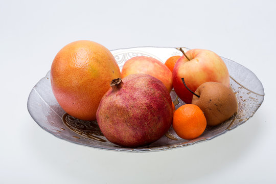 mix fresh fruits on plate isolated on white