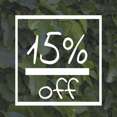 Sale fifteen percent off sign on green leaf background