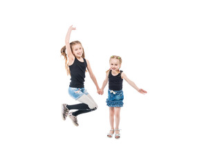 Two sisters playing, smiling and holding hands