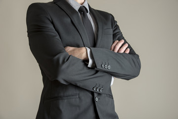 Torso of a businessman standing with folded arms