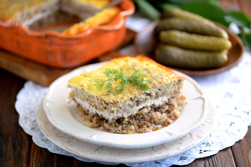 Casserole from buckwheat, mushrooms, onions, carrots and minced meat from chicken fillet.