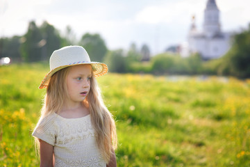 Portrait of a cute little girl in a hat