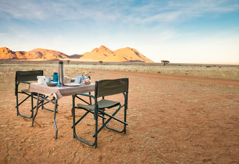 Camping table and chairs in the desert. Great view. Sunrise. - 158700229