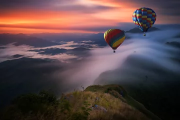  Hot air balloon over Pha Tang hill with beautiful mountain view and fog in morning, Chiang rai, Thailand © structuresxx