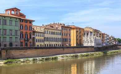 Fototapeta premium Pisa - historic townhouses along the Arno embankment. Small Gothic church of Santa Maria della Spina from 1230