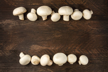 Overhead photo of white mushrooms on rustic texture with copyspa