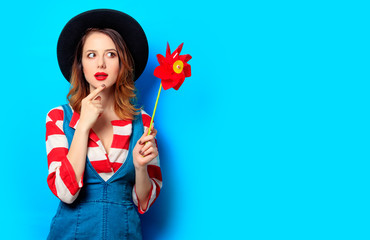 Woman with red pinwheel