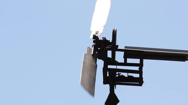 The windmill pumped water in Siberia against the blue sky.