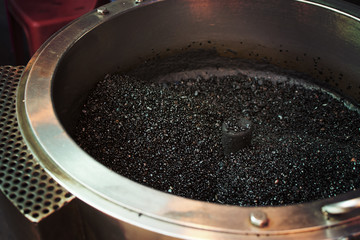 Hot pebble in a hot pan for roasting the chestnut. selective focus.