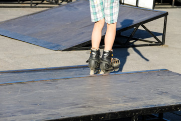 Roller skate legs closeup in skatepark