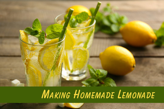 Two lemonades with lemons, mint and sugar cubes on wooden table background, closeup