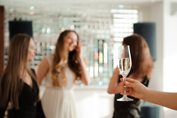 Group people with champagne dancing at the party.