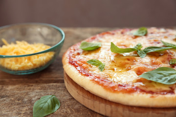 Tasty pizza on wooden table