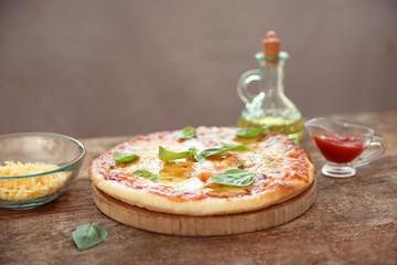 Tasty pizza on wooden table