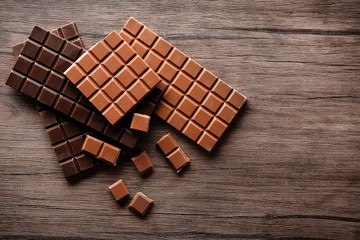 Chocolate bars on wooden background