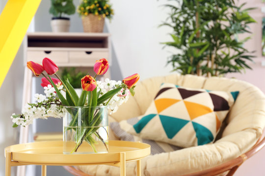 Vase with beautiful flowers in modern veranda interior