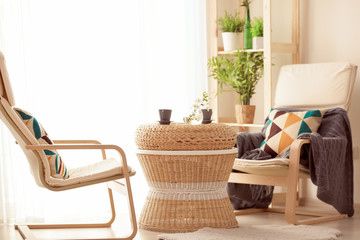 Beautiful modern veranda with cozy armchairs and coffee table