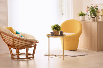 Beautiful modern veranda with cozy armchairs and coffee table