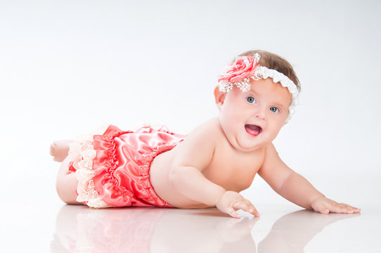 Fashionable smiling baby girl in pink panties