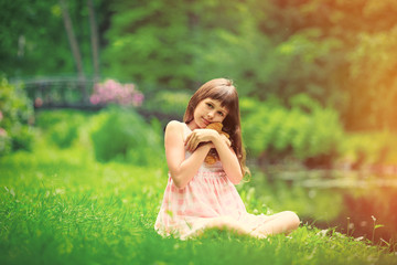 Little girl playing with teddy bear