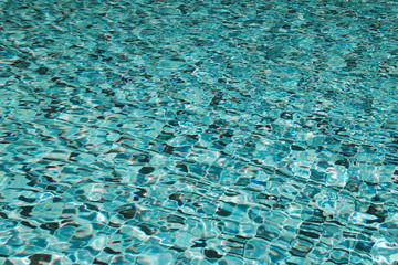 Transparent water in the swimming pool. Blue water texture for background.