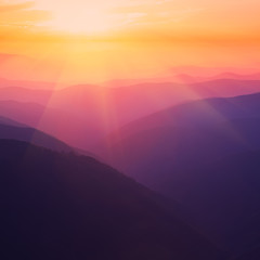 Naklejka premium Silhouettes of the mountain hills at sunset