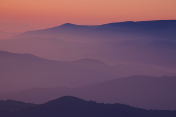 Fototapeta na wymiar Silhouettes of the mountain hills at sunset