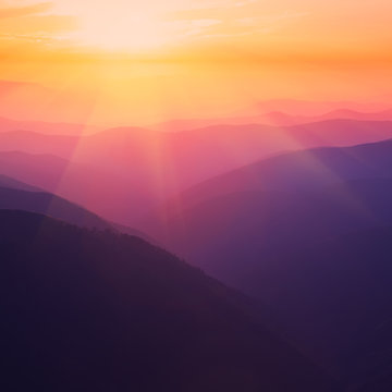 Fototapeta Silhouettes of the mountain hills at sunset