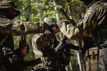 three military men shaking hands