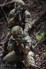 Military on assignment in woods
