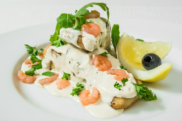 Delicious salad with tender shrimps, sauce, herbs and lemon. Horizontal frame