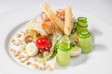 A delicious salad with fish, eggs, tomatoes and cucumbers. Horizontal frame