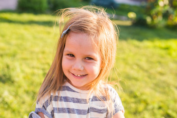 Portrait of sweet little girl play outdoors
