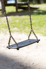 Empty wooden traditional swing on playground