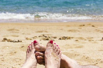 couple feet on the beach, turquoise sea,  love concept
